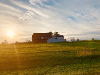 A rural landscape with a farm and a sunset, representing hope and renewal.
