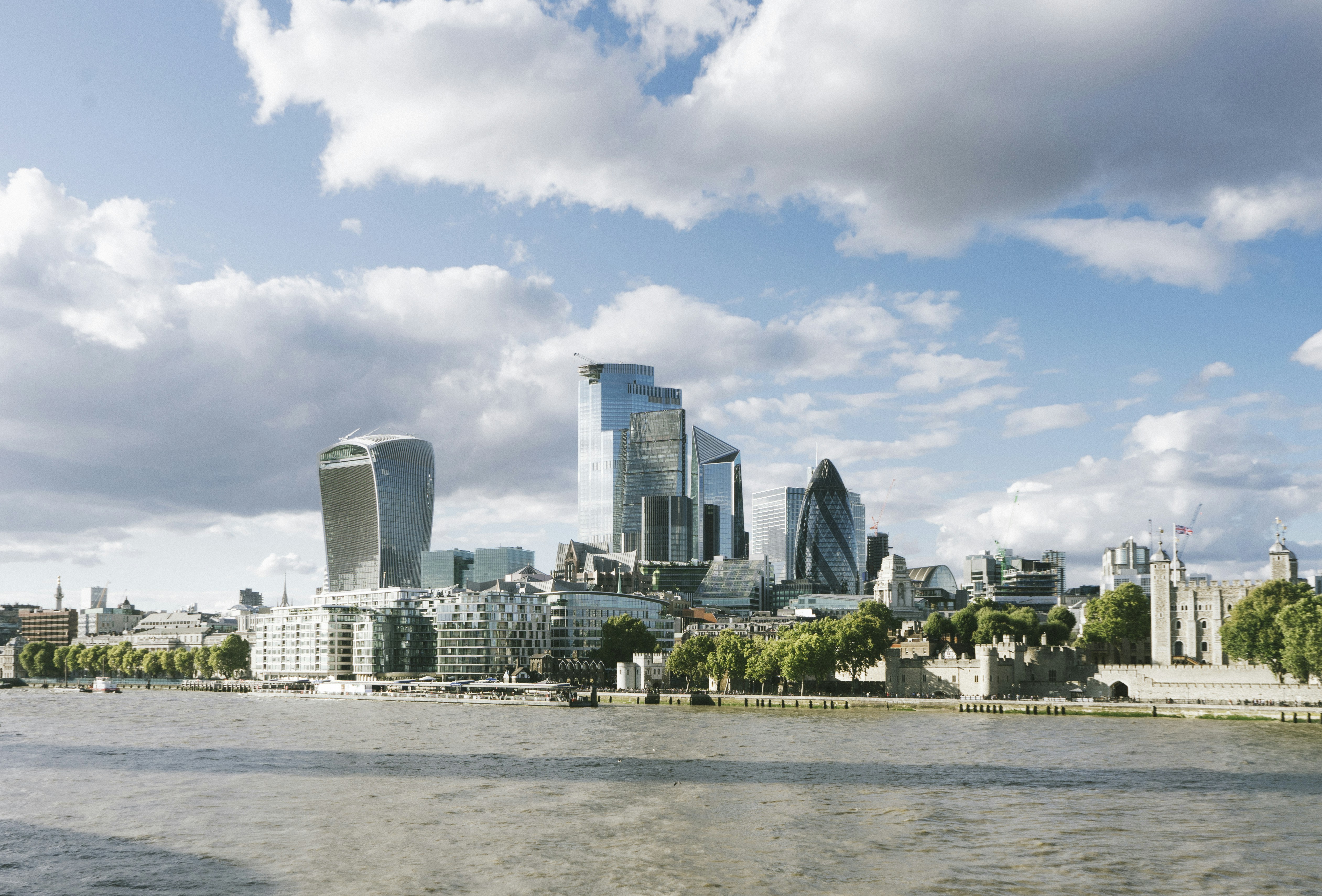 city buildings under blue sky and white clouds during daytime