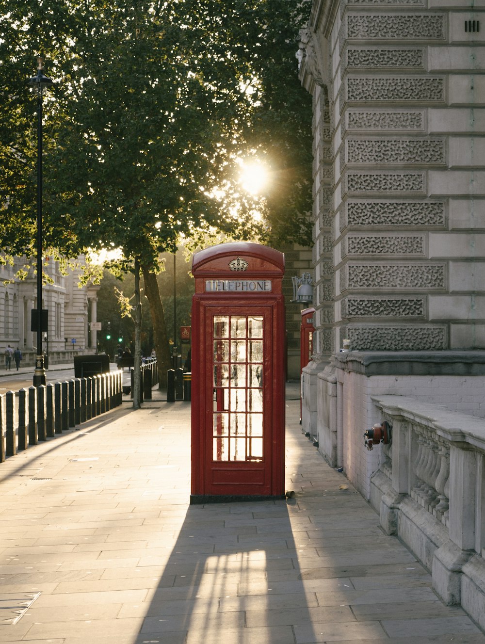 red telephone booth near building during daytime