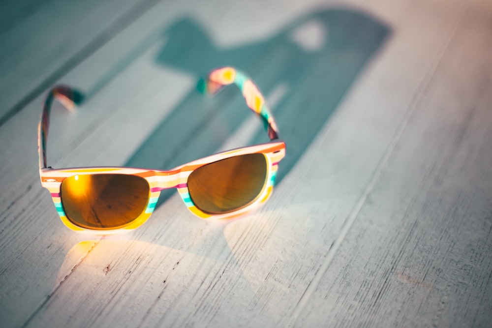 Foto de gafas de sol con montura amarilla sobre una mesa de madera marrón –  Imagen gratuita Gafas de sol en Unsplash