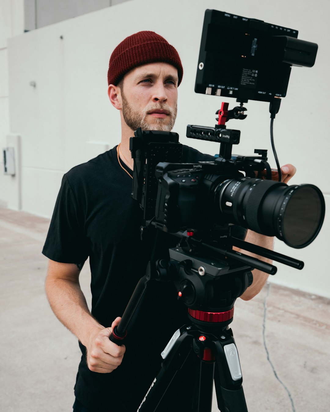 man in black crew neck t-shirt holding black video camera