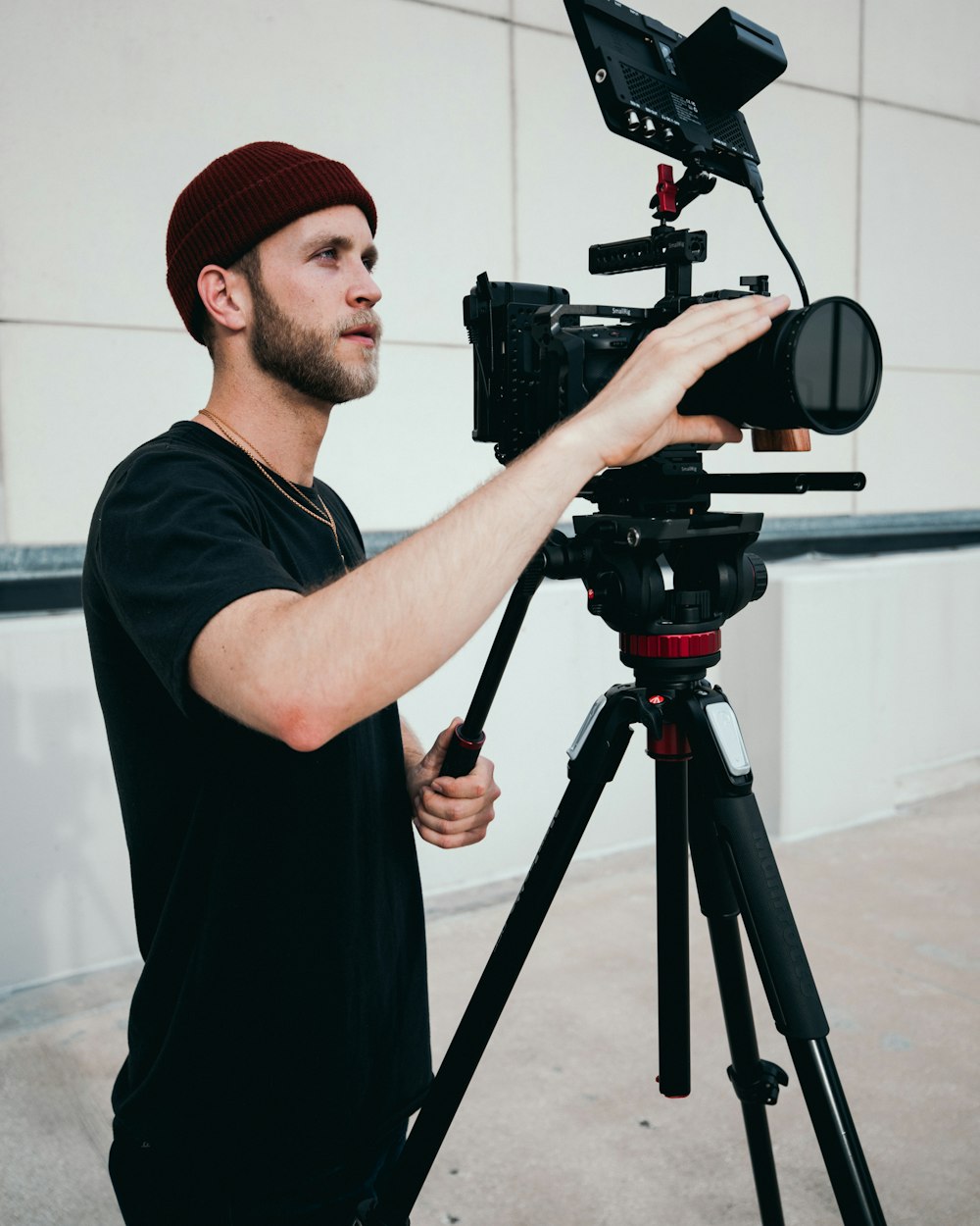 man in black crew neck t-shirt using black camera