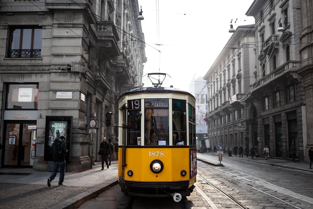 yellow and white tram on street during daytime