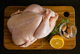 Close-up of fresh chicken and meat cuts on a wooden board