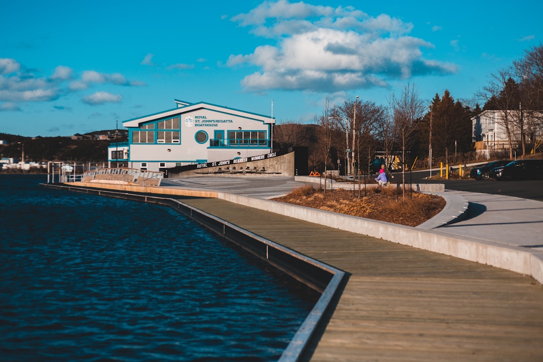 white and blue house beside body of water during daytime