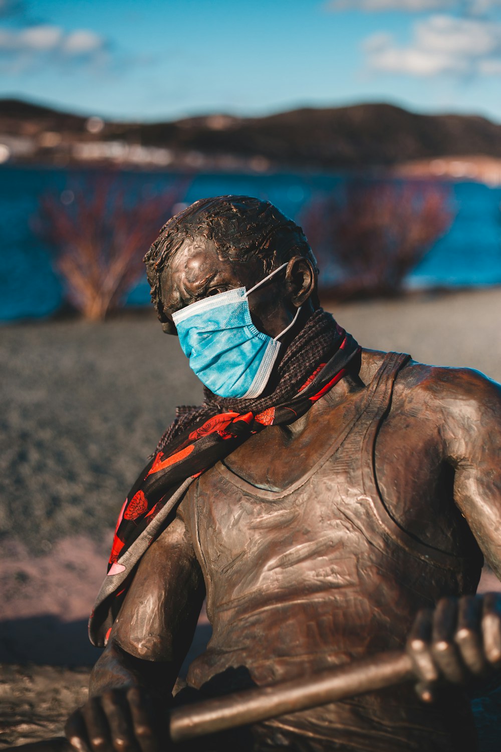 man in black leather jacket wearing blue and red mask