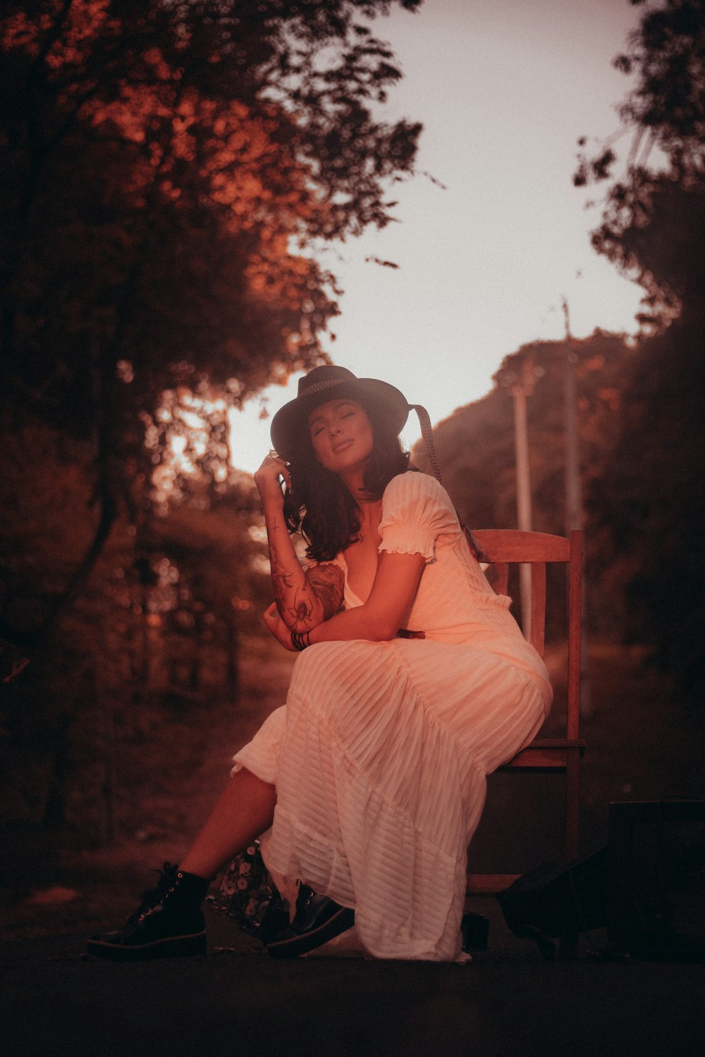 man and woman sitting on wooden bench during daytime