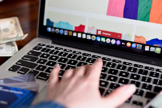 person using macbook pro turned on displaying game application