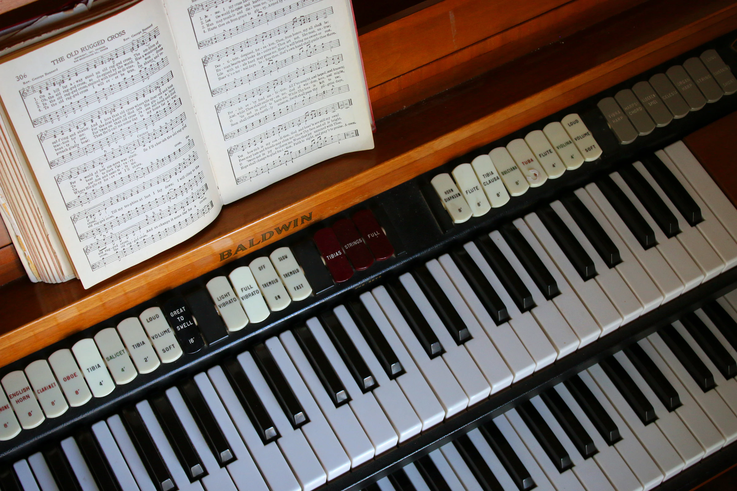 Hymnal resting on a piano in a church