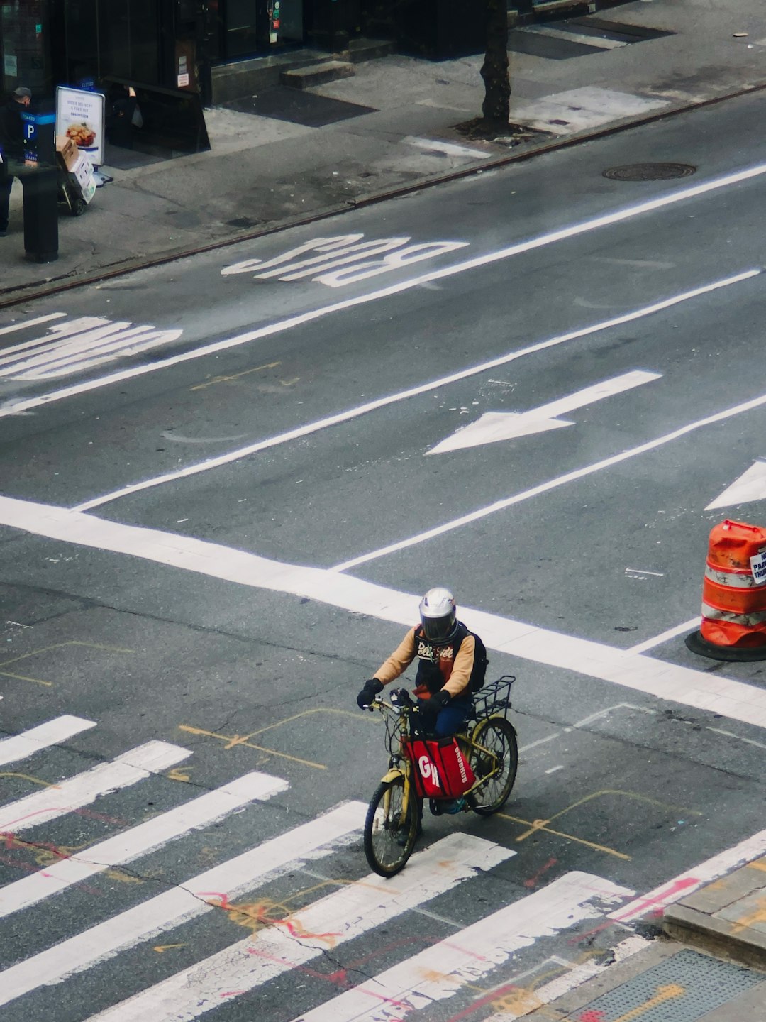 man in black jacket riding bicycle on pedestrian lane during daytime