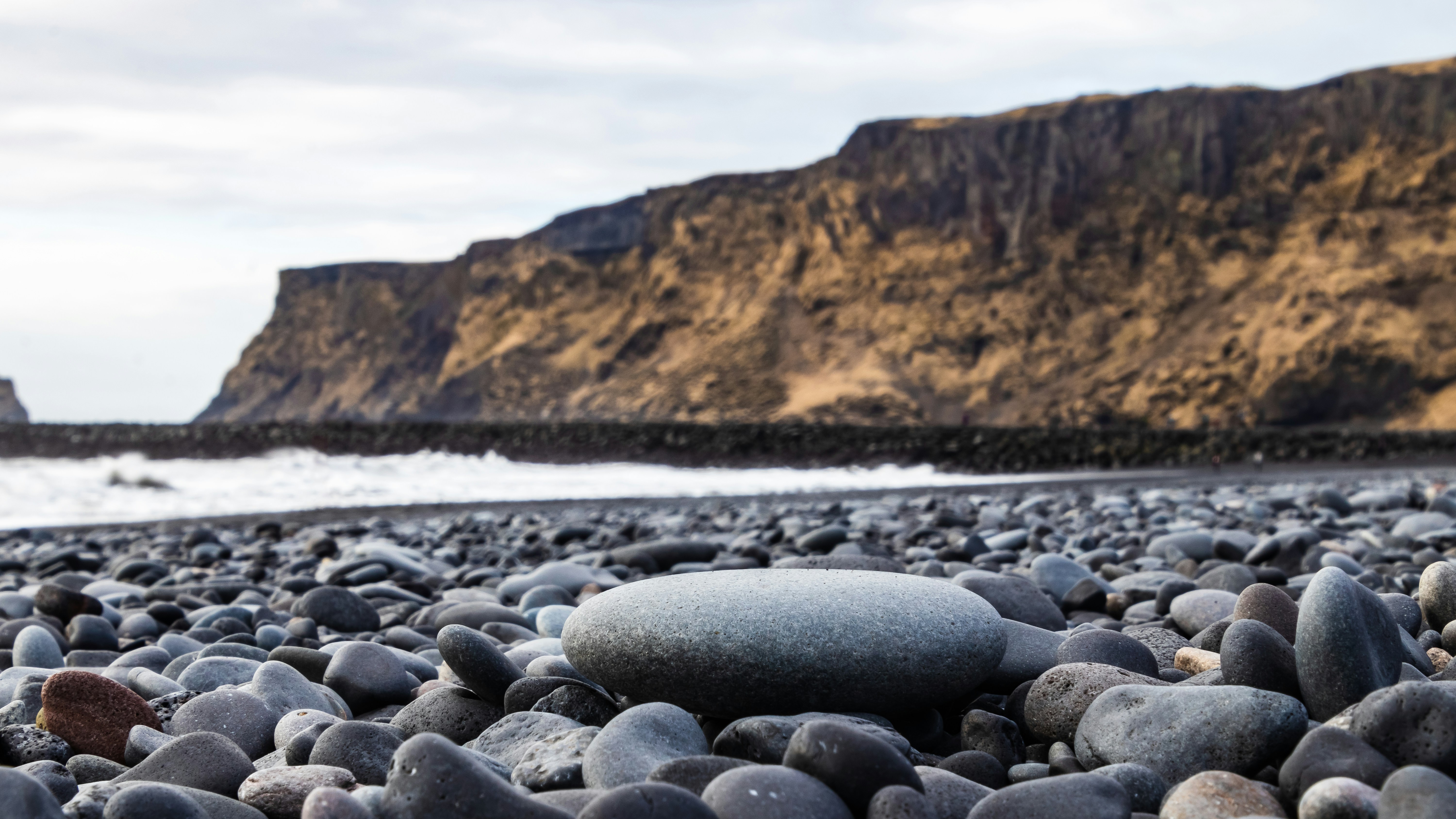 gray stones on body of water during daytime