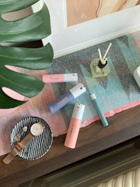 A vibrant arrangement of perfumes and personal care items with soft lighting.