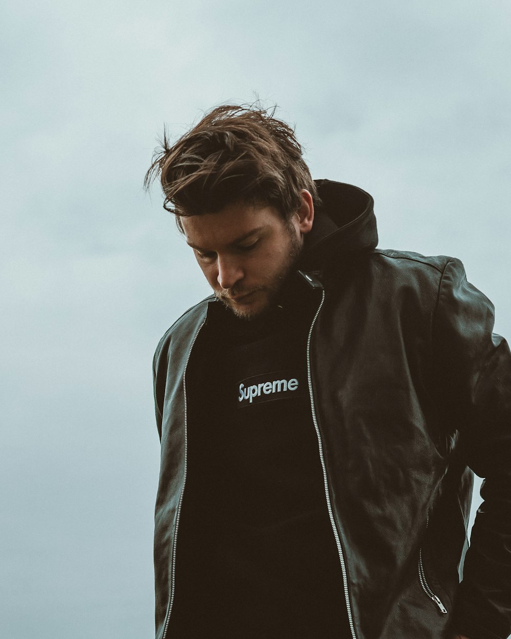 man in black and white adidas hoodie