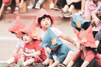 girl in pink shirt and blue shorts sitting on floor with girl in pink shirt