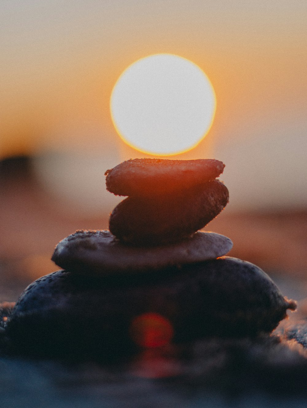 black stones with sun in the distance