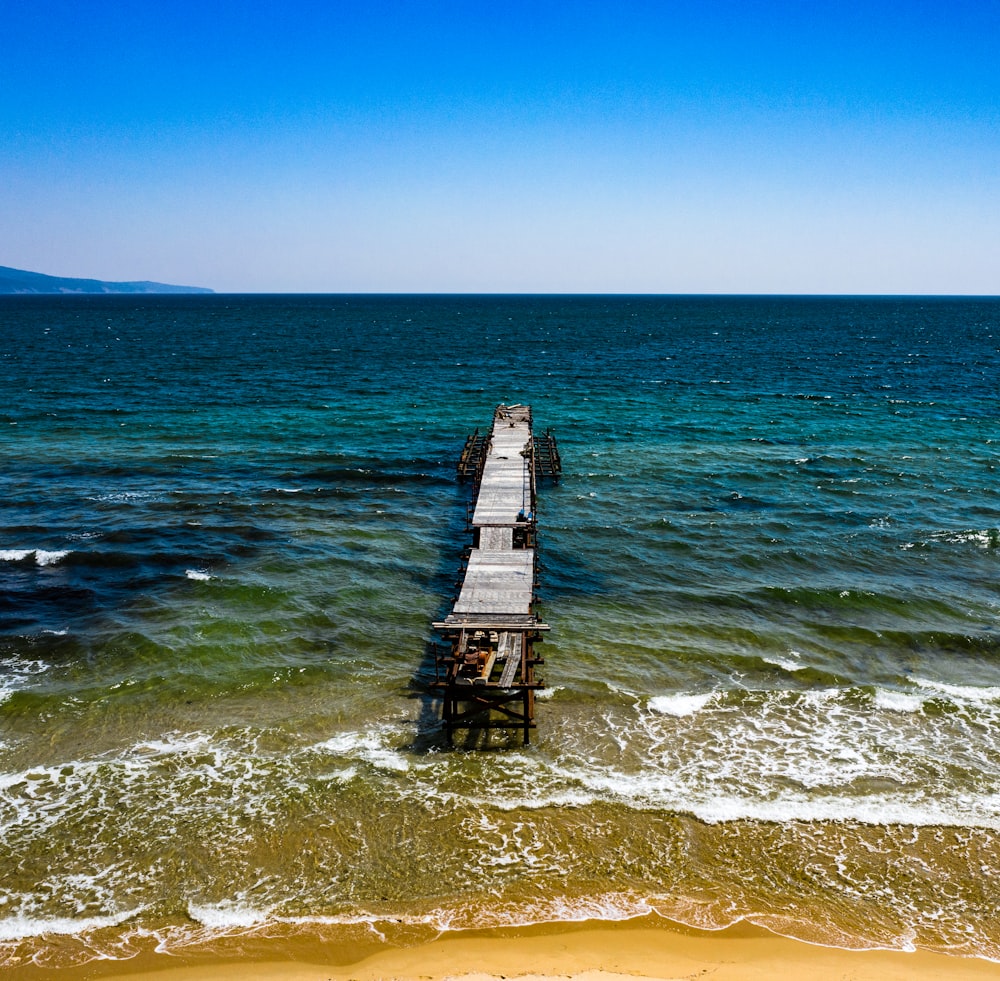 brown wooden dock on sea during daytime