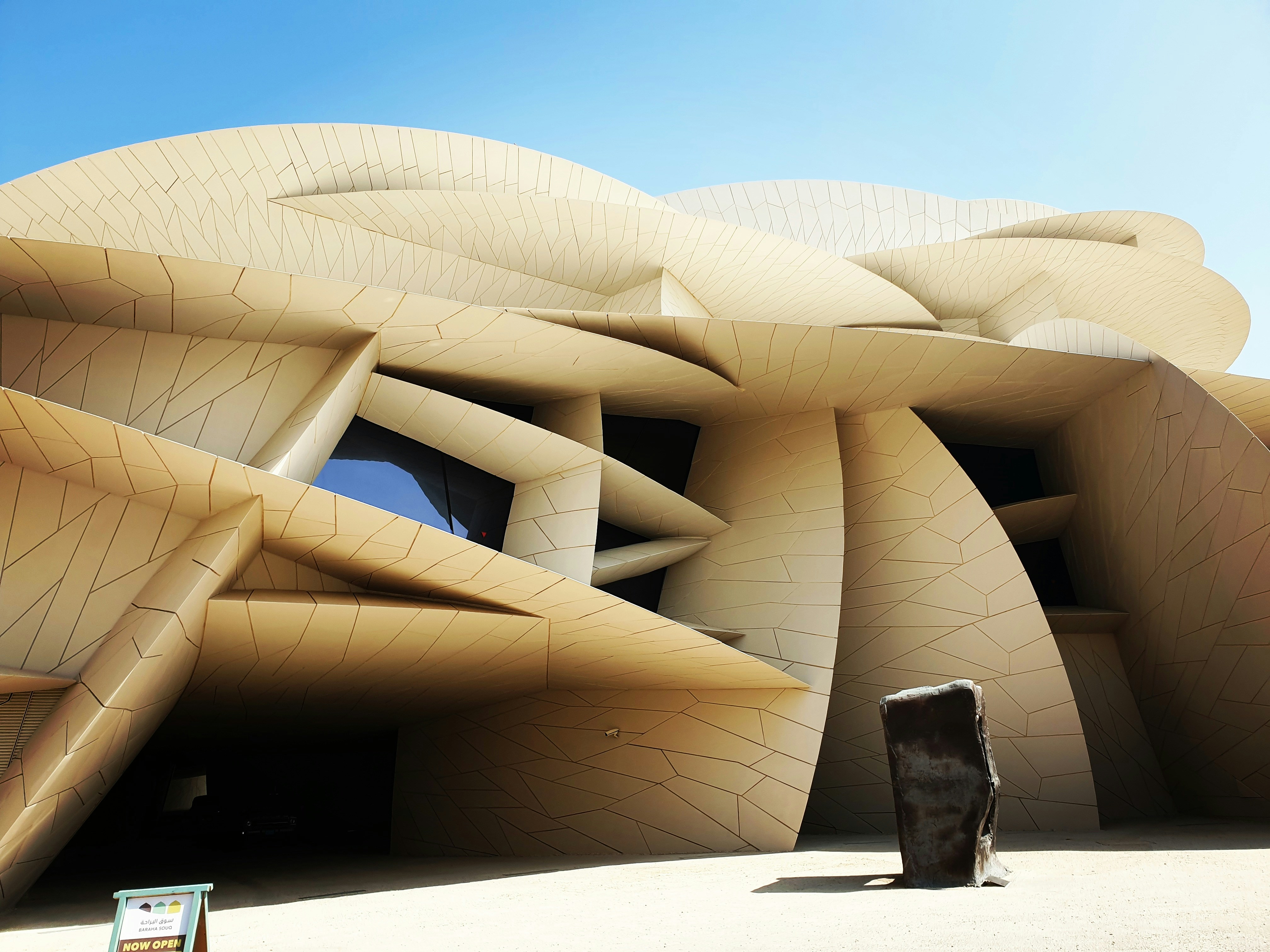 Low angle elevation view of the National Museum located in the capital city of Qatar, Doha. Opened to the public in the year 2019, the structure of this museum has been inspired by the desert rose found in Qatar.