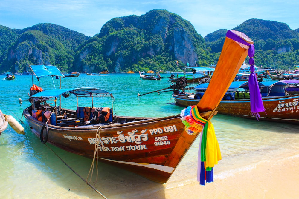 brown wooden boat on beach shore during daytime