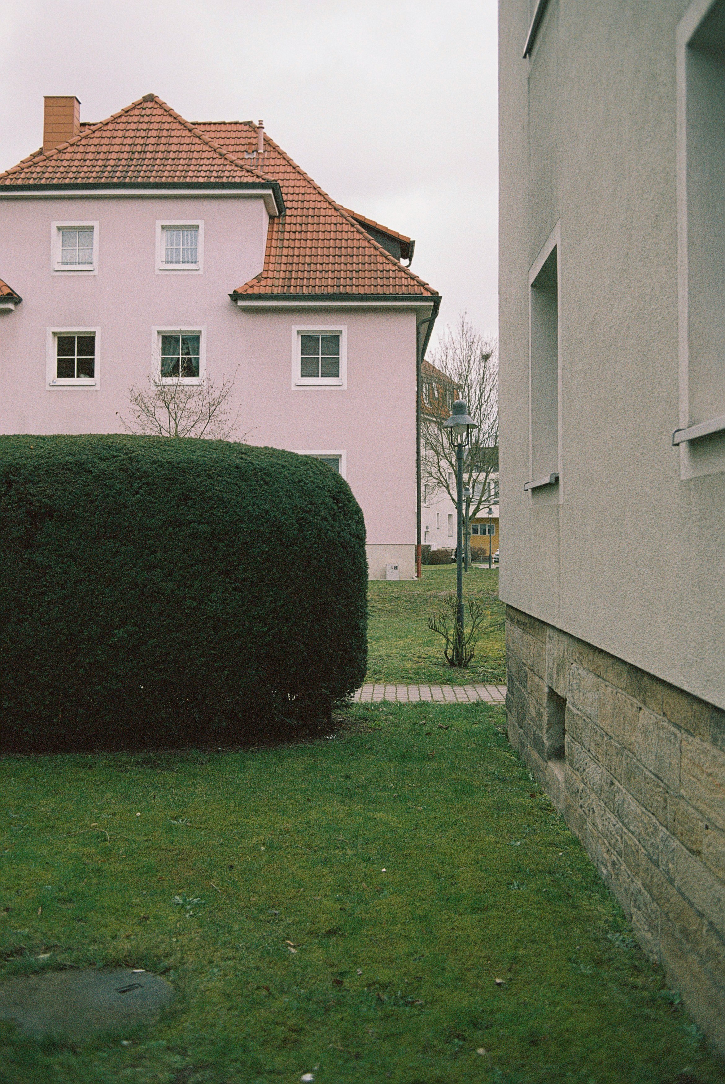 green grass field near white concrete building during daytime