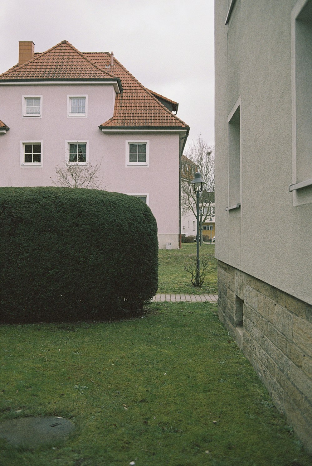 green grass field near white concrete building during daytime