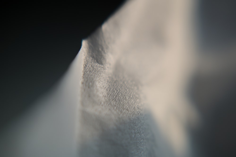 white textile on black surface