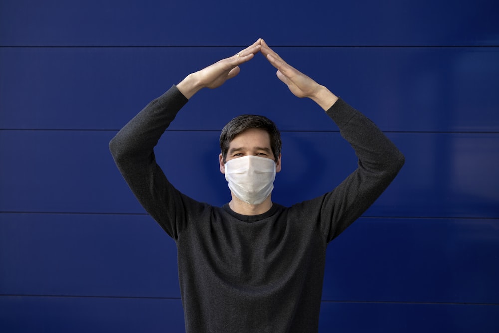 man in black long sleeve shirt wearing white face mask