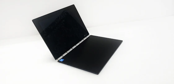 A sleek, modern laptop displaying the Menace Mobile Explained homepage with the Dr. Evil commercial video paused.