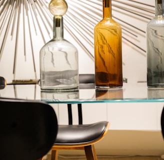 clear glass bottle of tonic on glass table