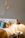 A cozy, sunlit bedroom corner with soft pillows and warm wooden accents creating a welcoming atmosphere.