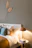 A cozy bedroom corner featuring a beautifully upholstered headboard in soft, inviting fabric.