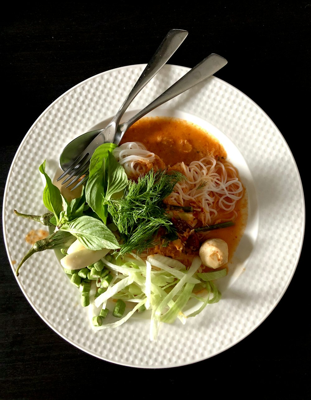 white ceramic plate with stainless steel fork and knife