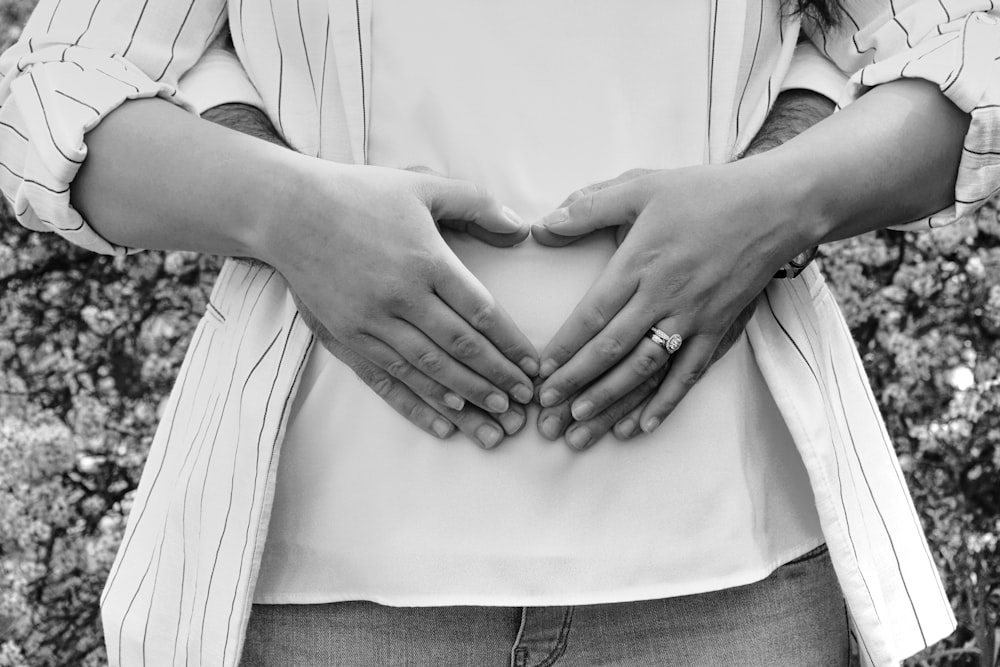 grayscale photo of person wearing ring