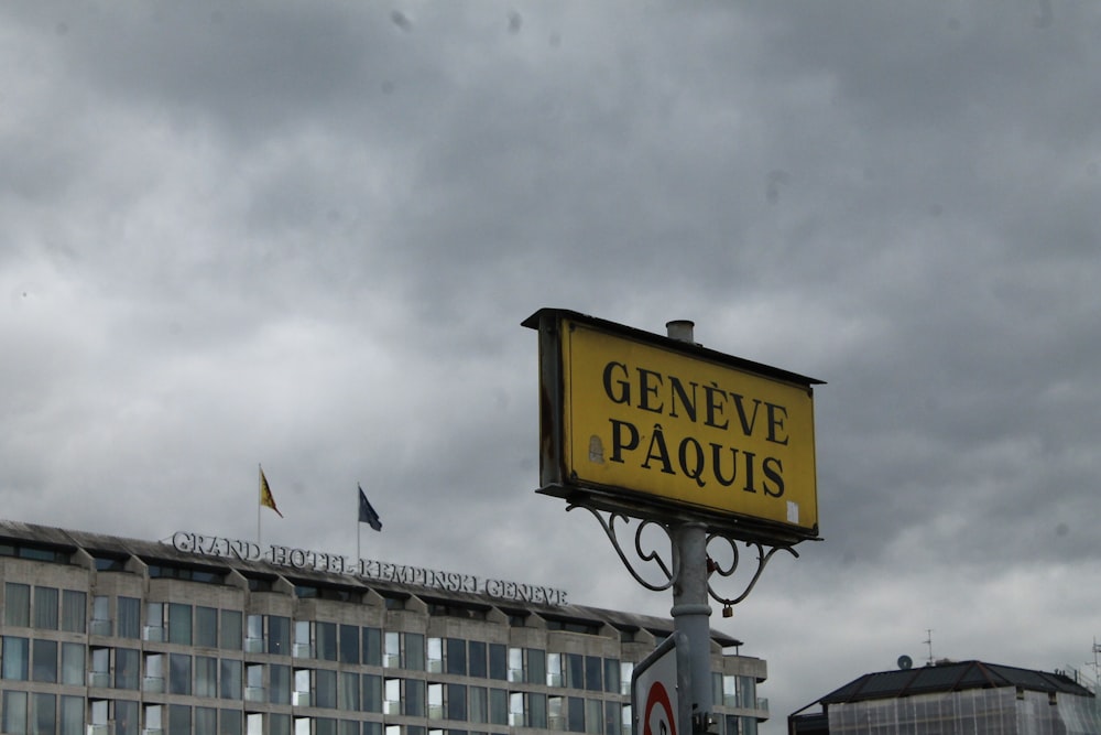 Un cartello giallo che dice Geneve Paquis davanti a un edificio