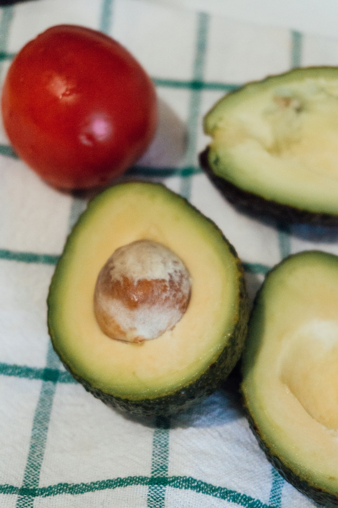 sliced avocado fruit on white and blue textile