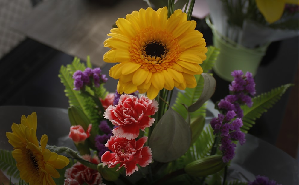 yellow sunflower in clear glass vase