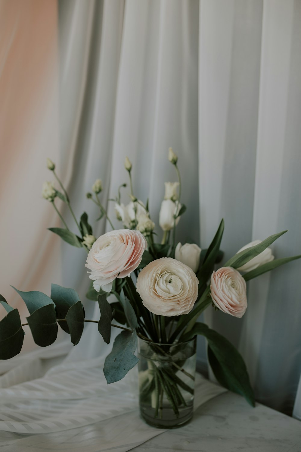white roses in glass vase