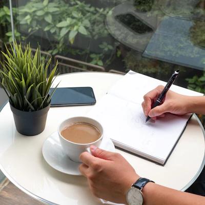 person writing on white paper