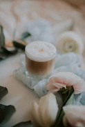 Creamy cheese foam tea in a clear cup with a delicate layer of foam on top, set against a soft pastel backdrop