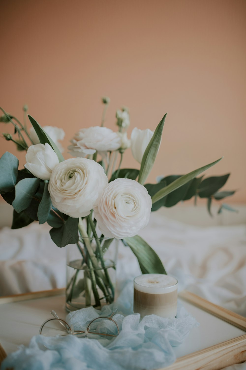 white roses in clear glass vase