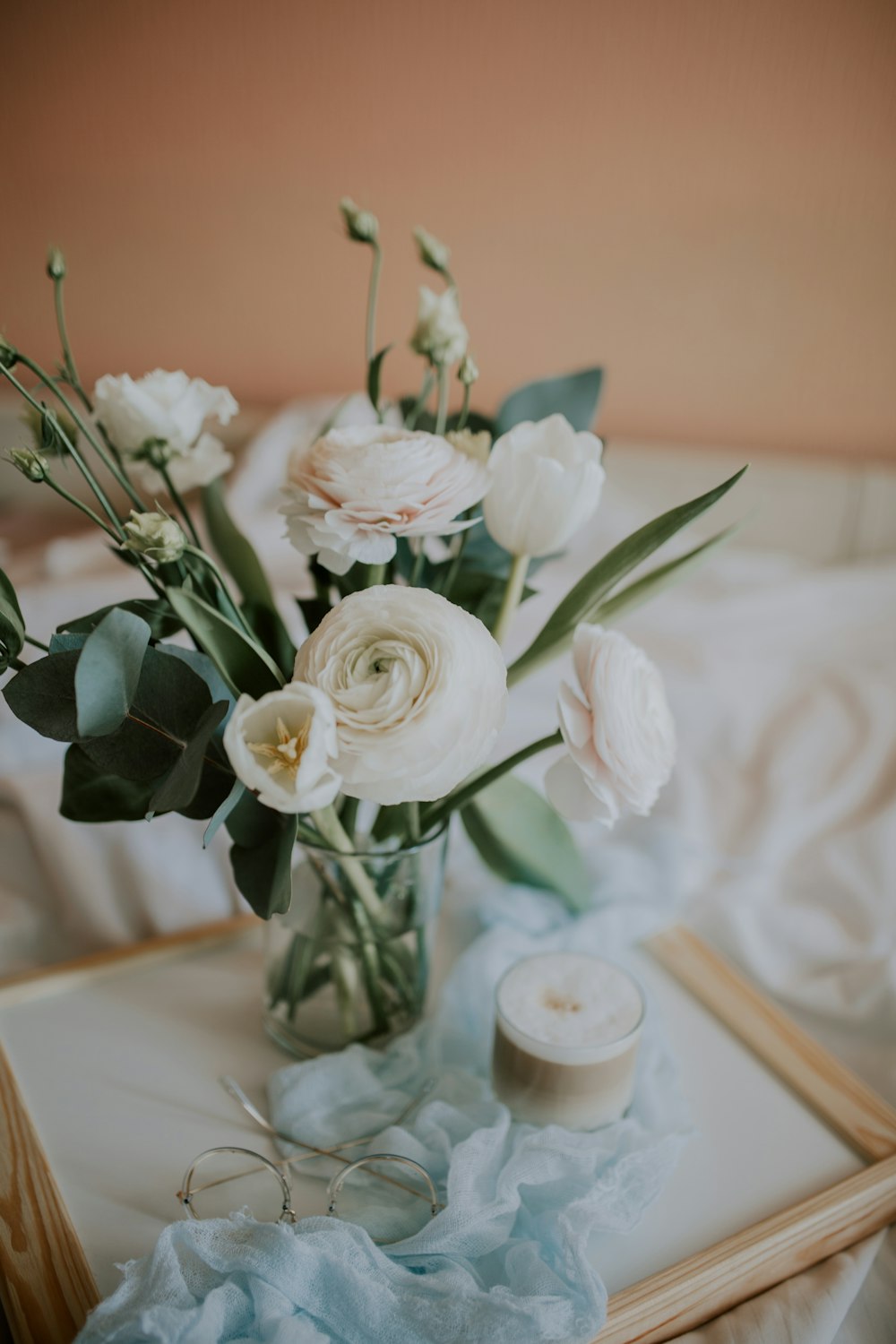 white roses in clear glass vase