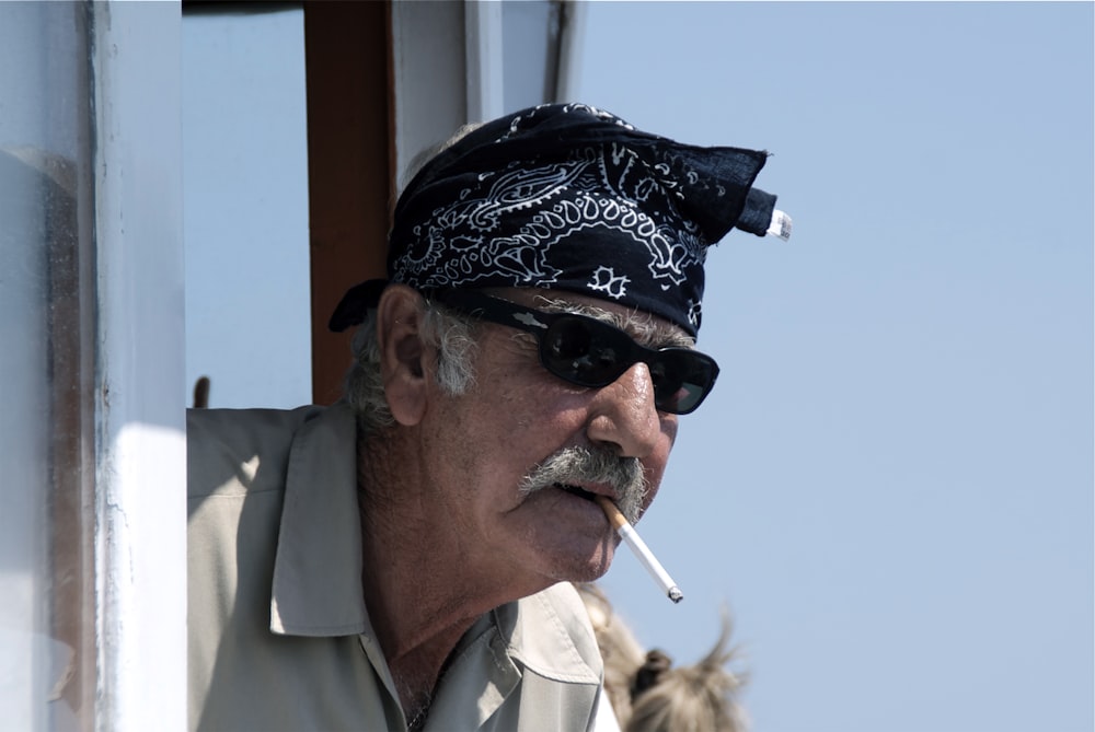 man in white button up shirt smoking