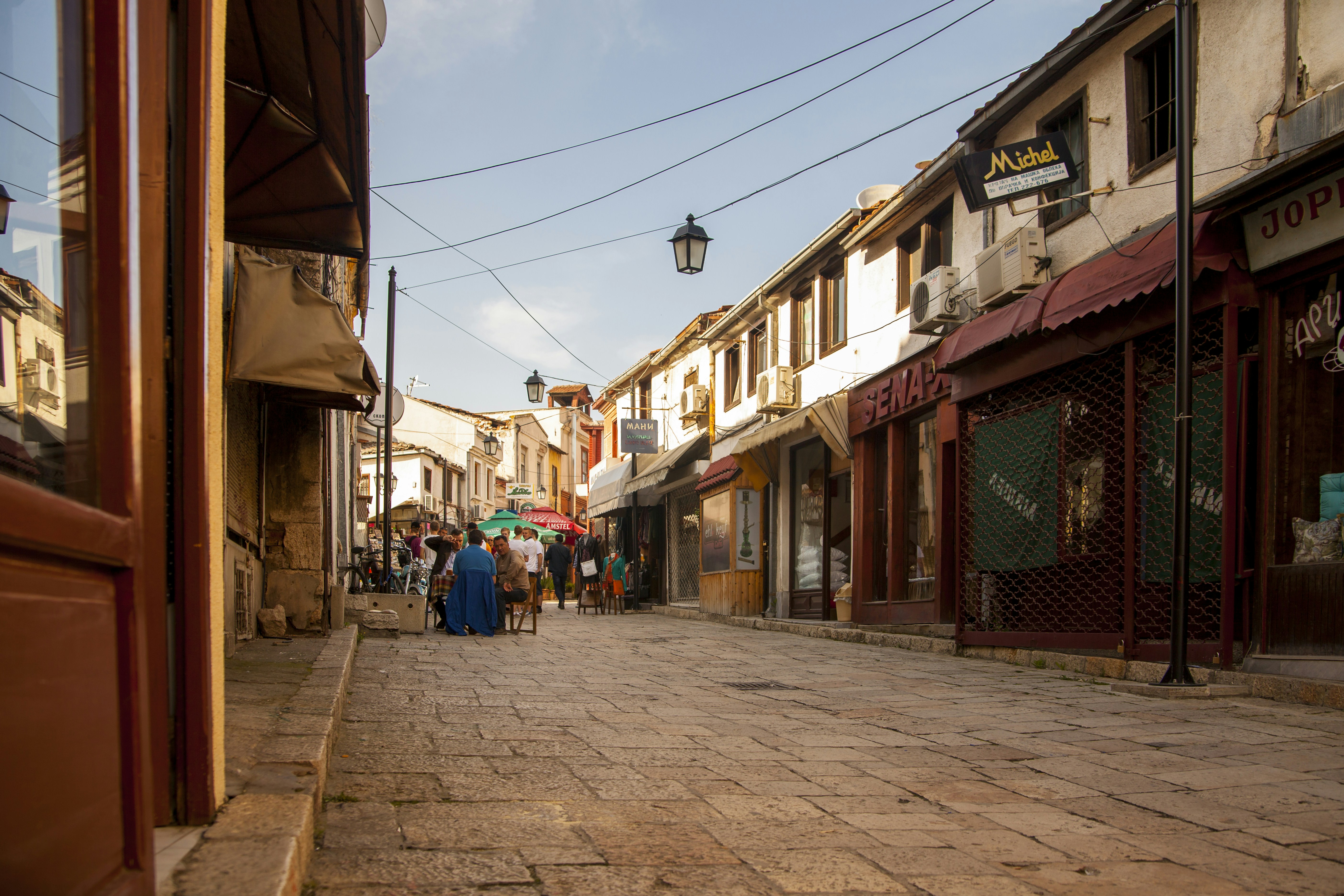 people walking on street between buildings during daytime north macedonia teams background