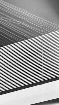 The image contains a series of diagonal lines that intersect and overlap, creating a pattern of varying densities. The lines appear to be white against a textured gray background, with some sections appearing denser than others.