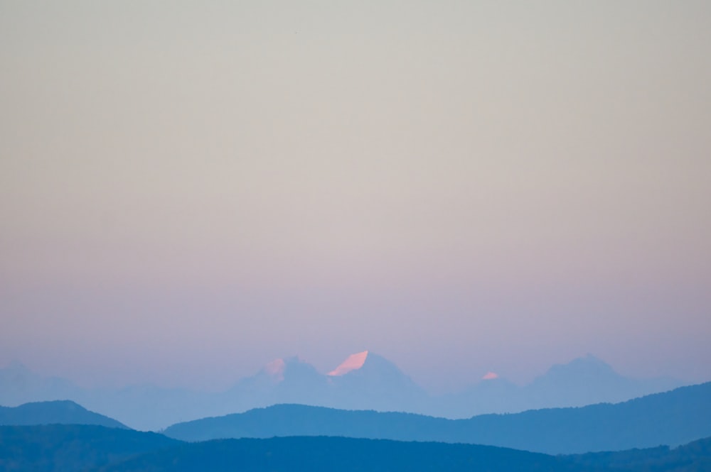 silhouette of mountains during foggy day