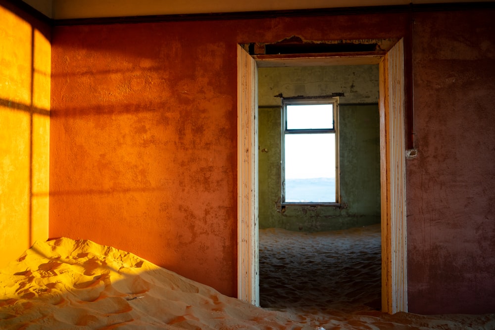 brown concrete wall with white wooden window