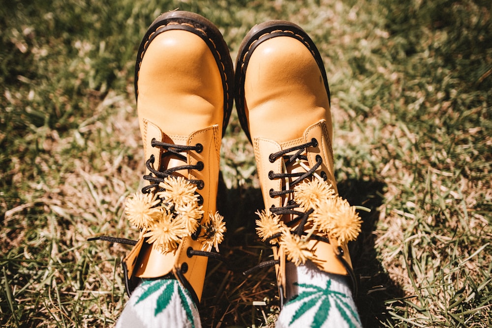 person wearing brown and black lace up shoes