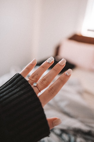 person wearing silver ring and black long sleeve shirt