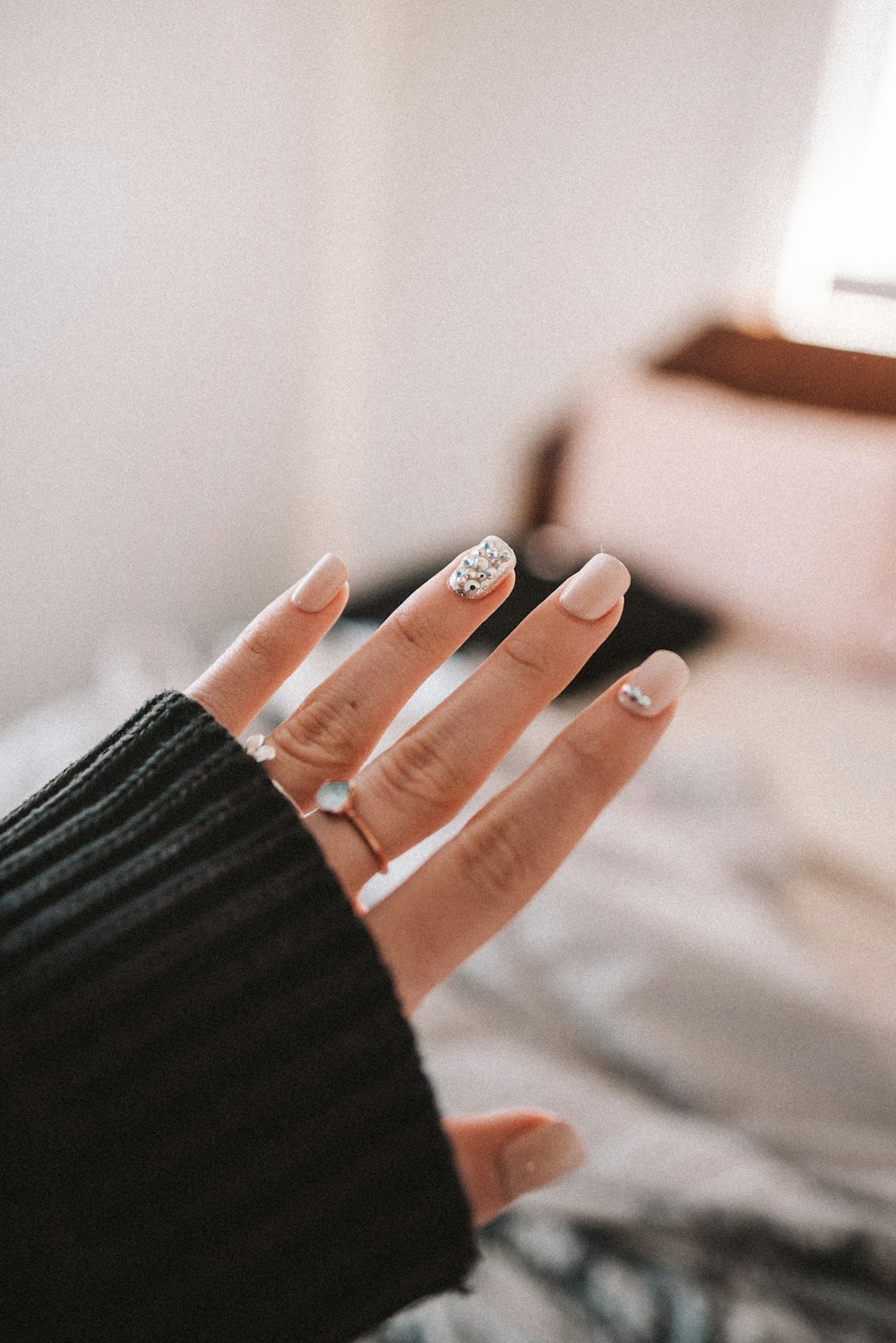 person wearing silver ring and black long sleeve shirt