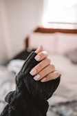 person in black long sleeve shirt holding black textile