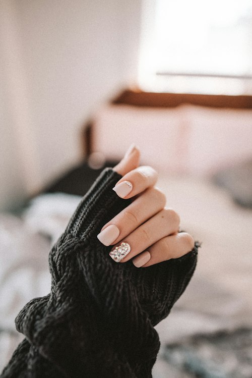 Glossy nude gel manicure with a shimmer accent nail